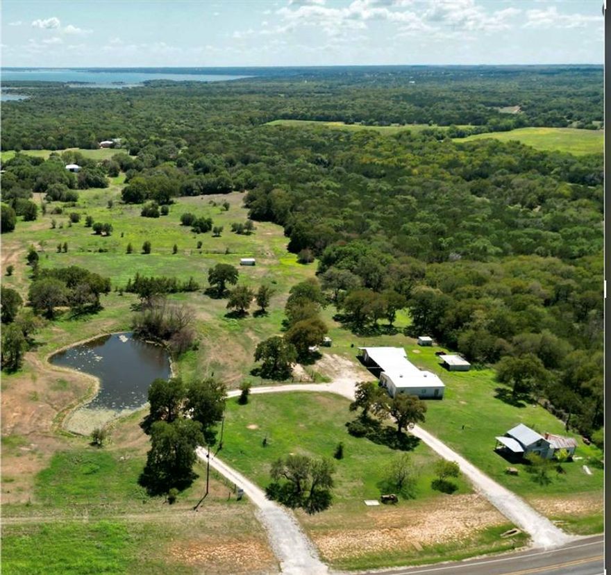 Beautiful Lake Whitney, multiple boat ramps, marinas & Brazos River are minutes away from this 4 acres located in Bosque County. Tank, wonderful trees throughout the property, cleared areas, barndominium, covered parking, circle drive , storage, workshop with a covered porch. Multiple metal covered areas for animals, barb wire fencing, some chain link. The property consist of multiple parcel ID’s