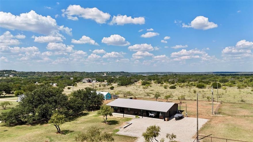 Located just a few miles from Lake Brownwood and only about 15 minutes from Brownwood, this beautiful 3-bedroom, 2.5-bath home sits on 1 acre of land. Built in 2021, the home offers an open-concept layout, combining the kitchen and living areas into a spacious and inviting space. The kitchen features a large island and all-electric appliances, with the exception of the refrigerator which may be negotiable.You'll find a spacious pantry and laundry room with hookups for added convenience. Enjoy breathtaking views from both the front and back covered porches, which extend along each side of the home.The primary bedroom is large enough to comfortably fit a king-size bed, and it includes a walk-in closet. The adjoining bathroom boasts a double vanity and a generous walk-in shower.In addition to the home’s luxurious interior, the property also includes an attached shop, providing plenty of space for all your workshop needs, complete with a half bath. With 2 RV hookups, it's the perfect space for family gatherings and guests.Nearby, enjoy fantastic amenities such as the Hide Out Golf Club & Resort, Wild Duck Marina, and the Lakeside Bar & Grill—all while embracing the tranquility of lakeside living. The home also has insolation in the ceilings & external walls and framed with 2X6 centers.Schedule your showing today to experience this incredible home!