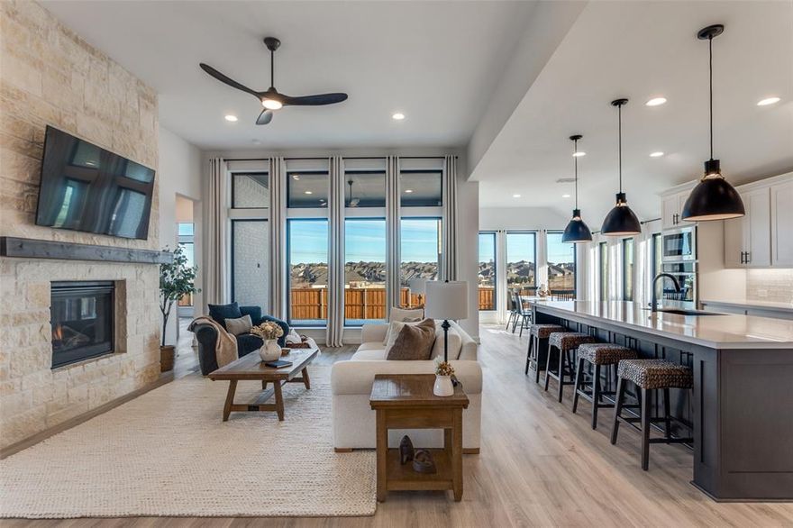 Tucked into a premier lot in the beautiful Ventana, this home isn’t just upgraded — it’s intentionally designed for the way you want to live! This exceptional home offers luxury from start to finish with extensive upgrades. With no homes directly to the left or behind, you’ll enjoy rare privacy, wide-open space, and peaceful backyard views. The expansive open green space creates a serene backdrop where deer are often seen, and walking trails connect throughout the neighborhood. An extended entryway warmly welcomes you into a dramatic living space featuring soaring 17-foot ceilings and an upgraded floor-to-ceiling stone fireplace that anchors the room beautifully. Upgraded long-plank laminate flooring flows throughout the majority of the home, including the primary bedroom, creating a seamless and modern feel. The kitchen is designed for both functionality and style, offering abundant cabinetry — including storage on both sides of the island that's made for your hosting dreams — upgraded double ovens, under-cabinet lighting, stunning quartz countertops, and a sleek black granite composite sink. Thoughtful upgrades continue throughout, including custom floor-to-ceiling curtains in every room. The private primary suite features a spa-inspired bathroom complete with an upgraded barn door entry and a luxurious freestanding soaking tub designed for relaxation. Beyond the home itself, Ventana provides outstanding community amenities including two swimming pools, walking trails, a dog park, playground, and BBQ areas. Nearby Whitestone Golf Course, convenient access in and out of the neighborhood, and directly down the street from the school. This is a rare opportunity to own a beautifully upgraded, move-in-ready home with premium lot positioning in one of Benbrook’s most sought-after communities. A rare opportunity to own something truly special in Benbrook — where elegance meets ease, and every sunset feels like it was meant just for you. Is this your perfect match?