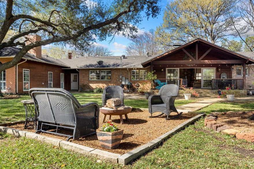 A Texas Hill Country–inspired retreat on .524 acres beneath mature crêpe myrtles in the heart of Casa Linda Estates. Outdoor living, a temperature-controlled wine cellar, and thoughtful renovation moments from White Rock Lake.

Expansive grounds designed for outdoor living. A massive covered entertaining pavilion overlooks terraced lawn space, creating natural areas for dining, gatherings, and evenings around the fire pit beneath mature trees.

Inside, vaulted ceilings, hardwood floors, and walls of glass invite natural light. A dramatic floor-to-ceiling stone fireplace anchors the great room while maintaining an easy flow to the dining and kitchen spaces.

The kitchen centers around a generous island, creating a natural setting for gathering and relaxed evenings with friends and family.

A striking highlight is the temperature-controlled wine cellar with capacity for approximately 1,500 bottles, an exceptional feature for collectors and entertainers.

The secluded, massive primary suite offers a stone fireplace, tranquil backyard views, an expansive walk-in closet, and a spacious bath.

Three additional private bedrooms allow a flexible layout adaptable for office, study, or additional bedroom space depending on a buyer’s needs.

In 2017 the home underwent a significant renovation and expansion adding approximately 1,000 square feet. System improvements bring peace of mind: a newer hot water heater, updated HVAC ductwork, ultraviolet air purification, hot water recirculation, French drain systems, and PVC plumbing within the newer addition.

A rare East Dallas property where country atmosphere meets city convenience. At 1402 Verano: Space. Privacy. Lifestyle. Location.