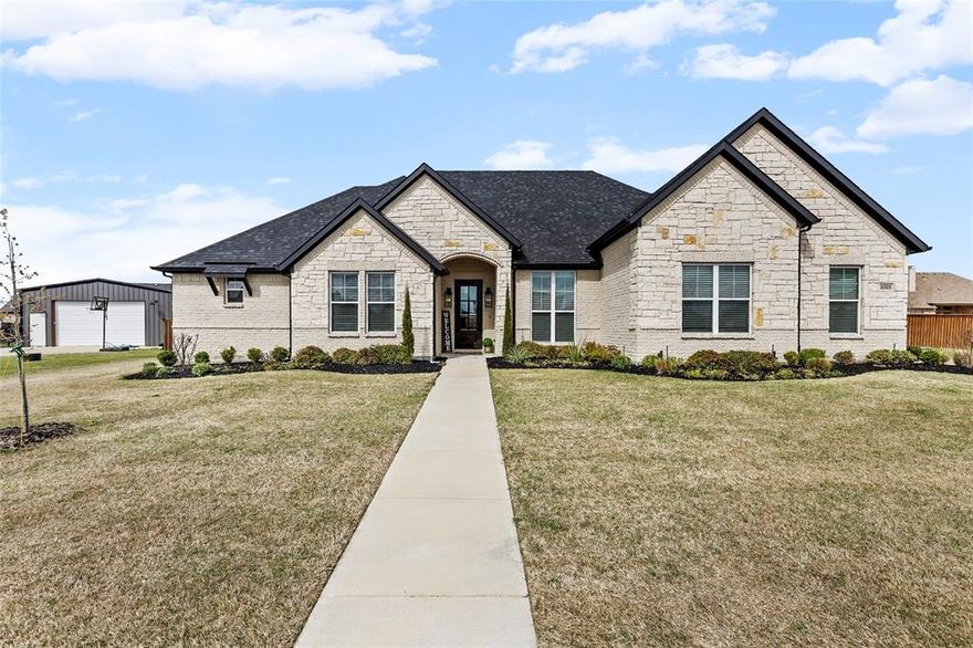 Custom 4 Bedroom 3.5 Bath with additional office space located in the exclusive The Mills subdivision. This beautiful home features a Brick and Stone exterior is located on over .5  acre large lot for plenty of elbow room. Inside you find great open concept living space, vaulted ceiling, custom built-in entertainment center, white stone gas fireplace and custom hand scrapped hardwood floors thru the main living area. The extra large marble island (with eating area) highlights the spacious kitchen that offers a gas cooktop, built in stove & microwave, walk-in pantry, custom cabinetry to the ceiling and much more. The large primary bedroom features tray ceilings, ceiling fan, barn door entering  a ensuite bath area with jetted tub, separate walk-in shower, dual vanities and sinks with custom his and hers walk-in closet that opens to a large laundry room with linen closet and excess to a mudroom near the garage entry. The other primary features marble sink and walk-in shower. The 3rd and 4th bedrooms each have their own walk-in closets, private vanities and sinks and sharing the Jack & Jill bath. Located near the entry of the home you have a Bonus Room that is perfect for some office space, a playroom or many other options. This home has numerous custom features throughout such as engineered foundation post tension, heat pump HVAC, 2 tankless water heaters, cellulose all stay insulation, 8' doors, marble countertops, irrigation system and large windows allowing for an abundance natural lighting. The oversized garage allows parking as well as plenty of storage space. Located on the back patio you have additional gas stone fireplace with TV and hookups for propane stove offering a great area for relaxing and  entertaining. The private backyard has a custom wood privacy fencing and a dog run. Located with very easy access to I30 (Greenville & Rockwall) restaurants & shopping, schools, daycare and the heart of Caddo Mills Tx.