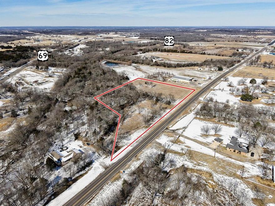 5.06-acre C-1 zoned commercial lot in Bells, TX, located just south of Dollar General at 810 Ole Ambrose Rd. Approx. 747 ft of road frontage with easy access to Hwy 69 & Hwy 82. Within city limits with water meter, fire hydrant, and city sewer connections in place. Partially treed with creek on property. Excellent visibility and strong development potential.