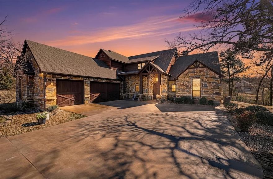 Welcome to Resort style living in Texas! This stunning custom home sits among mature trees on a rare double cul-de-sac lot in the premier Rock Creek community. Offering privacy and seclusion all within a golf cart ride of some amazing amenities. This 3777sqft luxury home offers 5-bedrooms, 4.5-baths, multiple living areas all with high end finishes. Rich wood cabinetry and trim throughout, hand scraped wood floors, travertine and granite counters, stone and slate tile. An open floor plan lets you live and entertain seamlessly. The great room shows cathedral ceilings, grand stone fireplace with pellet stove insert and tons of natural light from the many windows. Kitchen has stainless appliances, island, walk-in pantry and eat at counter. Formal dining space overlooks the patio and backyard. Just off the main living is a fantastic den or flex space with wet bar, kegerator and beautiful pocket doors. On the main floor, a spacious primary bedroom features a designer ensuite bath and his & hers closet which connects to the laundry. The home also conveniently has a secondary main floor bedroom suite for guests or multigenerational living. Upstairs, there is a spacious game room, full bath in the hallway and great balcony. Two large bedrooms with walk in closets share a jack n jill bath and the final bedroom also has a walk in closet and great nook space. Stepping out back the patio and double terrace spans the entire length of this stately home. It is the ultimate space to live life and entertain. This home was built to bring people together.  There is fresh interior paint and roof was recently replaced. This is move in ready! Rock Creek is a way of life and some of the amazing amenities include an 18 hole Jack Nicklaus Championship Golf Course, Clubhouse and Restaurant, Private Lake Texoma access with Boat Docks and Marina, Private Pool and Pool House, Cross Timber Trails, Fitness Center and Hotel, including the new Waterfront Rooms and 24-7 Security.