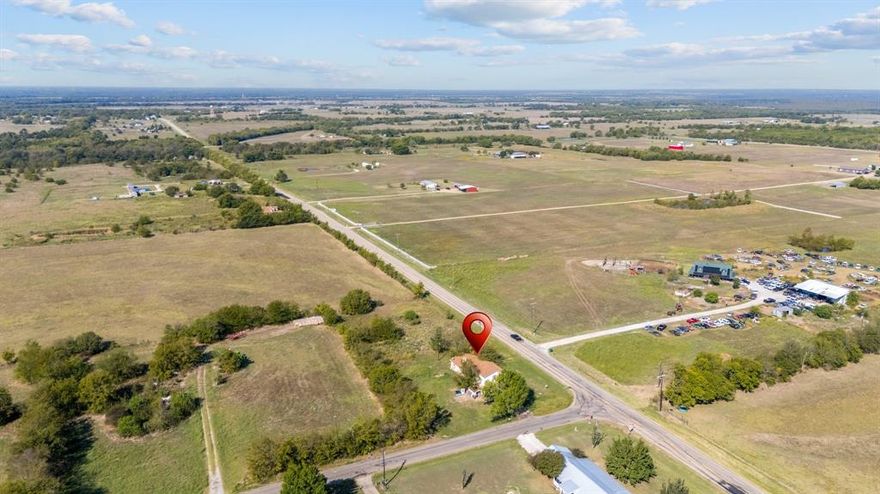 Discover this charming brick home with 5 bedrooms and 2 baths, situated on a spacious corner lot just outside city limits, offering over an acre of land. With ample road frontage and fencing on two sides, this property provides both privacy and great curb appeal. One bedroom features a convenient kitchenette, perfect for guests or a home office. The generous layout includes plenty of room for family gatherings and outdoor activities, making it a great place to entertain. While the home is ready for your personal touch, it presents a wonderful opportunity to create your dream space. Enjoy the peaceful surroundings while having easy access to local amenities.