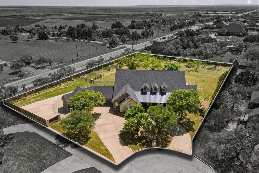 Located in the highly desirable gated Vaquero Ranch neighborhood. This home sits on an 1.5 acre lot at the end of a private cul-de-sac. Ample parking with circular front drive and extended driveway with porte-cochere, that wraps around the detached garage-pool house and offers secondary access. 3-car attached garage, 2-car detached garage, 2 covered porte-cochere spaces, and a large back concrete pad with endless possibilities. Landscaped front yard with mature trees. Large covered front patio with dual French door access and main entry. Wood flooring throughout all common areas. Remolded kitchen with custom wood cabinets, leathered granite counters, 8 burner gas range stove, commercial grade vent hood, and built-in refrigerator. Spacious primary suite with fireplace and French door back patio access. En-suite includes dual sinks, walk-in shower, and soaking tub. Additionally, the primary bedroom has 2 spacious custom closets combining for over 300 Sqft. of dressing area and storage space. Additional bedrooms are spacious and offer flexibility for family, guests, or office space. Expansive outdoor living space with covered patio, built-in gas grill with vent hood, putting green, and custom pool. Pool house space connected to the detached garage, providing an additional private and flexible living space. The expansive yard, spacious living area, abundant parking and private setting make this the perfect home for entertaining.