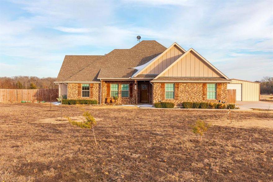 Experience peaceful country living with breathtaking sunrises and sunsets on this 1.51-acre property. This beautiful home features 4 spacious bedrooms, 2 full bathrooms, a half bath, and a 2-car garage. Inside, you’ll find 10-foot ceilings with crown molding, engineered wood floors, and ceiling fans throughout. The tiled entryway opens to a welcoming living area complete with a wood-burning fireplace and a cedar mantle perfect for cozy evenings. The kitchen has custom-stained oak cabinets, granite countertops, and a huge walk-in pantry. Step outside to enjoy a covered back patio overlooking the expansive backyard, offering incredible views, ideal for entertaining or relaxing. A 30x60 shop with a large door connecting to the barn provides plenty of space for projects, storage, or livestock. The property is fully fenced and cross-fenced, making it ideal for horses or other livestock. This property truly combines comfort, style, and rural charm; everything you need for serene country living.