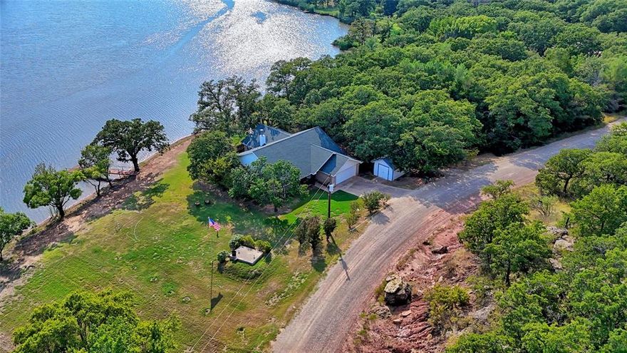 A leader in the neighborhood with this private Leisure Lake waterfront opportunity. 3-bedroom 2 bath home on 3 lots. Recent all-inclusive additions to sale include kit. fridge, 75 in TV & 2 comfy chairs, family size safe, carpet in 2 bedrooms,12 ft Jon boat-motor-winch. Roof shingles 2024+-& recent hot water heater. Workable kitchen, lots of counter space, & cabinets. Appliances stay in place. Large table dining & allows extra seating from the multi-purpose room with seasoned views of lake that can be used for extended gatherings, additional sleeping arrangements, game room, workout area, 2nd living, or work from home office. Never ending possibilities. Living has a focal WBFP & total open concept with airy ceilings to give a roomier feel. Accommodated main bedroom with walk-in closet & full private bath. Two extra bedrooms with hall bath for guest & relaxing jacuzzi tub. Handy utility counting washer-dryer, room for chest freezer that is included & step in pantry. Garage with work benches & extra fridge. Separate golf cart storage. Cozy up-front porch for morning coffee. Back boasts yard spots for a fire pit, cookouts with the bonus gift Weber grill while enjoying lots of good gab. Evenings can be spent sitting on the dock fishing & taking in the indescribable sunsets. Full tree covered lot for separation. Safe storm shelter & to complete the premises is a straight from seedling vegetable garden already in bloom. Make this your weekend rural retreat get-away or a perfect primary home. Absolutely nothing but peaceful scenes surround this property. Majority of furniture will stay with the sale. Proximity to the Oklahoma Casinos & downtown Nocona for the year-round activities, shopping, & good clinic, hospital, & pharmacy. Manned 24 hr. gate at the entrance, community boat ramp, golf, air strip, etc. Bears Cafe just outside the gate. 2 hr. courtesy showing notice please. On the horizon plans for a clubhouse, 19th Hole, & Pro Shop. Access with an agent only.