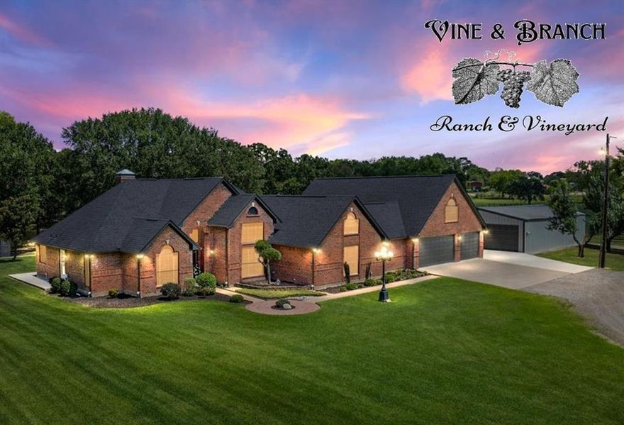 Vine & Branch Ranch has also become a well-loved site for weddings and family gatherings and photos. Its and excellent location, near HWY 198 and HWY 175 only 45 minutes from the DFW Metroplex, makes this an ideal setting for an Event Center or Winery. A Countryside Dream Estate, Over Twenty Acres of Pure Texas Living! Welcome to your retreat located in the quiet countryside, where almost twenty AG-exempt acres bring together natural charm and upscale comforts. Open pastures, grand oaks, and calm ponds set the stage for a lifestyle of tranquility, recreation, and opportunity. A picturesque tree-lined driveway leads past your private vineyard to a fully updated home, designed with meticulous care. The charming brick house boasts high-end finishes, large windows that welcome sunlight, a cozy living room with a fireplace, and a farmhouse-style kitchen. Spa-inspired bathrooms, along with rooms for crafting or media, extra storage add even more character. The main house includes 3 bedrooms with oversized walk-in closets, a loft and 2 bathrooms with a connected 3-car garage. A separate one-bedroom, one-bath guest home (900sf) comes complete with its own kitchen and generous living area, making it ideal for guests or creative pursuits. Venture outside to find a Field of Dreams – your private baseball field and lighted basketball court, perfect for family activities or evening practices. Take a dip in the sparkling pool or unwind in the hot tub, surrounded by expansive covered decking and patio spaces, ideal for gatherings. Wine enthusiasts will be delighted by the irrigated and carefully tended grapevines with over 700 plants.