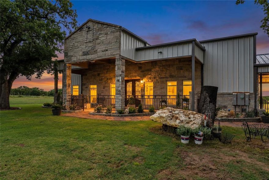 Luxury Ranch Living Stone Finished Barndominium on 5.9 Acres
Experience the pinnacle of rural sophistication at 945 Jennings Lane. This master crafted, stone-finished barndominium offers over 3,400 sq. ft. of high-end living space, perfectly situated on 5.9 lush, Ag-exempt acres. Boasting a rare blend of modern luxury and ranch functionality, this estate is a premier opportunity for cattle, horses, or those simply seeking total privacy within reach of the DFW Metroplex.
The interior is a showcase of upgraded finishes throughout, anchored by a chef-inspired luxury kitchen designed for elite entertaining. The spacious floor plan features 4 bedrooms and 3.5 elegantly appointed baths, offering plenty of room for family and guests. Every detail, from the flooring to the fixtures, reflects a commitment to quality and style.
Outdoor Oasis and Infrastructure:
An expansive outdoor patio features a full outdoor kitchen, leading to a serene pond and dedicated sitting area nestled among mature trees. A massive 50x60 heavy duty shop see additional notes this provides ample space for equipment, a car collection, or a professional workspace. Parking includes a generous covered attached carport integrated into the home's design. 
over half  acre stock tank pond with catfish, crappie, perch, with exquisite viewing area
Expansion Opportunity:
For those desiring more land, an additional 6 acres are available for purchase, allowing for a total of nearly 12 private acres. This property offers the ultimate in tranquility and security. It is a turnkey luxury ranchette that provides a quiet escape without sacrificing proximity to city amenities.
Additional notes: shop 50x60. x 30in height 2 12 ft doors 1 14 ft door- 2 walk in doors additional 18000 square ft upstairs in shop- full bathroom- RV outlet, home has 2 250 gal propane tank- 2 finished bedrooms in 3rd floor