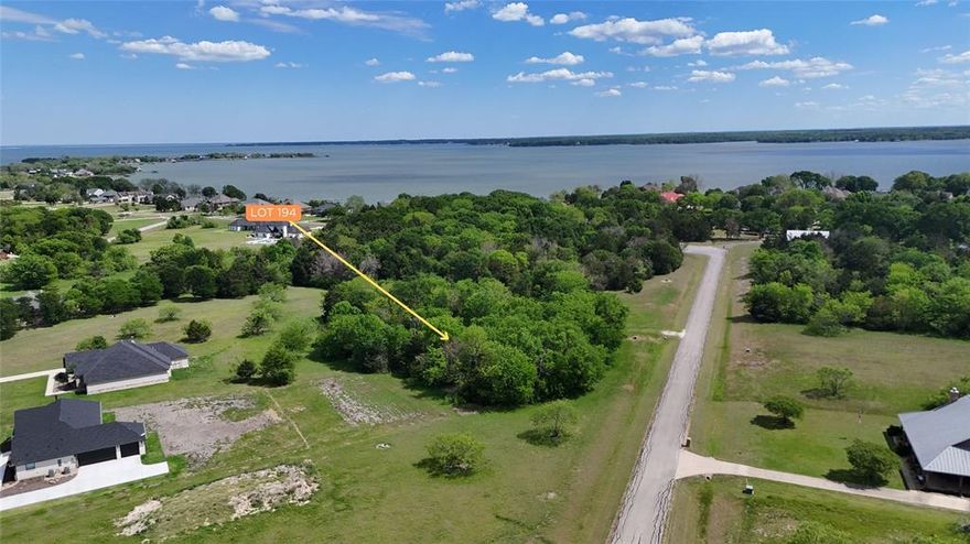 Tucked within the rolling landscape of The Shores on Richland Chambers Lake, Lot 194 offers a beautiful blend of natural beauty, privacy, and scenic lake-area surroundings. This 1.124-acre residential lot is gently contoured and richly wooded, creating a peaceful, park-like setting that feels both secluded and connected. Mature trees blanket the property, providing dappled shade, natural screening, and the perfect backdrop for a custom home thoughtfully nestled into the landscape.

From the lot, you'll be drawn toward the shimmering expanse of Richland Chambers Lake, visible just a from The Shore's community dock and park. The elevated feel and positioning within the community create a sense of openness, with long sightlines, soft breezes, and ever-changing light reflecting off the water. Whether enjoyed from a future front porch, back patio, or second-story balcony, the setting invites relaxed mornings and quiet evenings surrounded by nature.

The lot’s generous size and organic shape offer flexibility for home placement, outdoor living spaces, and preserving the natural canopy that makes this property so appealing. Neighboring custom homes and paved roads reinforce the established, well-maintained character of the subdivision, while the surrounding greenery adds to the feeling of calm and retreat.

Located in Mildred ISD, this interior lot delivers the best of lake-community living—scenic views, privacy, and room to breathe—without the upkeep of direct waterfront ownership. Whether you envision a refined primary residence or a tranquil weekend escape, Lot 194 provides an inviting canvas in one of Richland Chambers Lake’s most desirable gated communities.