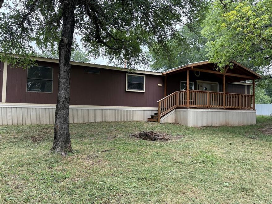 Great location between Granbury and Weatherford, check out this opportunity for you to live on just over half an acre with 1700+ sq ft of living space in Big Timbers with no HOA. Spacious rooms, new HVAC and dishwasher, new decks, built-in storage, and split floorplan make this a comfortable living arrangement. See through fireplace separates the living spaces. Kitchen overlooks the front yard and has plenty of counterspace and cabinets. Primary bedroom has ensuite bath with separate tub and shower. Two additional bedrooms share a full bath with tub-shower. Large wooded corner lot has potential to add an additional structure with 2nd septic for investment or multigenerational living or a garage-shop. Parker county schools and taxes.