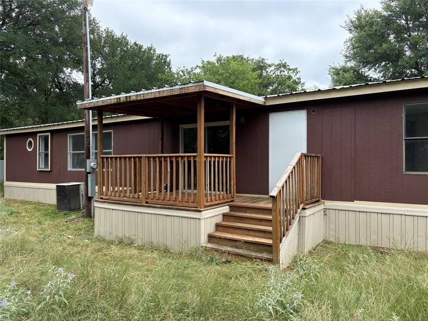 Great location between Granbury and Weatherford, check out this opportunity for you to live on just over half an acre with 1700+ sq ft of living space in Big Timbers with no HOA. Spacious rooms, new HVAC and dishwasher, new decks, built-in storage, and split floorplan make this a comfortable living arrangement. See through fireplace separates the living spaces. Kitchen overlooks the front yard and has plenty of counterspace and cabinets. Primary bedroom has ensuite bath with separate tub and shower. Two additional bedrooms share a full bath with tub-shower. Large wooded corner lot has potential to add an additional structure with 2nd septic for investment or multigenerational living or a garage-shop. Parker county schools and taxes.