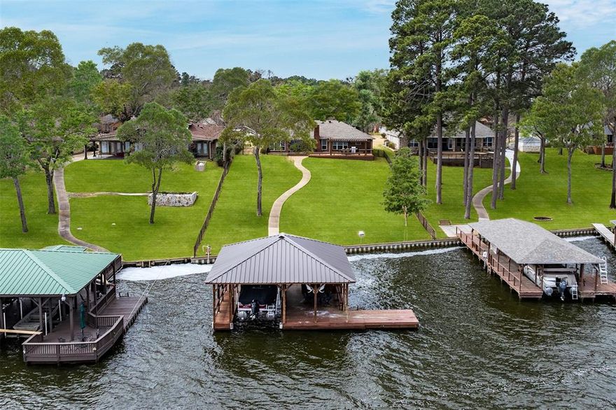 Charming Lakefront Retreat with Panoramic Views of Lake Palestine.
Welcome to this wonderful 3-bedroom, 2.5-bath home nestled in a gated community, offering spectacular views of beautiful Lake Palestine. The open-concept den, kitchen, and entertainment areas feature wall-to-wall windows that frame the serene lake, creating a tranquil backdrop for everyday living and entertaining.
Step outside to an expansive deck that overlooks a deep lot leading to a fabulous boat dock—designed with built-in fun for lakeside living at its best.
The spacious primary suite includes an oversized shower, twin walk-in closets, and ample room to relax. Enjoy cozy evenings by the stone fireplace in the den, while built-ins in the dining room add character and storage.
Additional highlights include generous storage throughout and a versatile bonus room with a day bed—perfect for guests or a home office.
This lakeside gem is ready for making memories. Come see the lifestyle that Lake Palestine has to offer!
