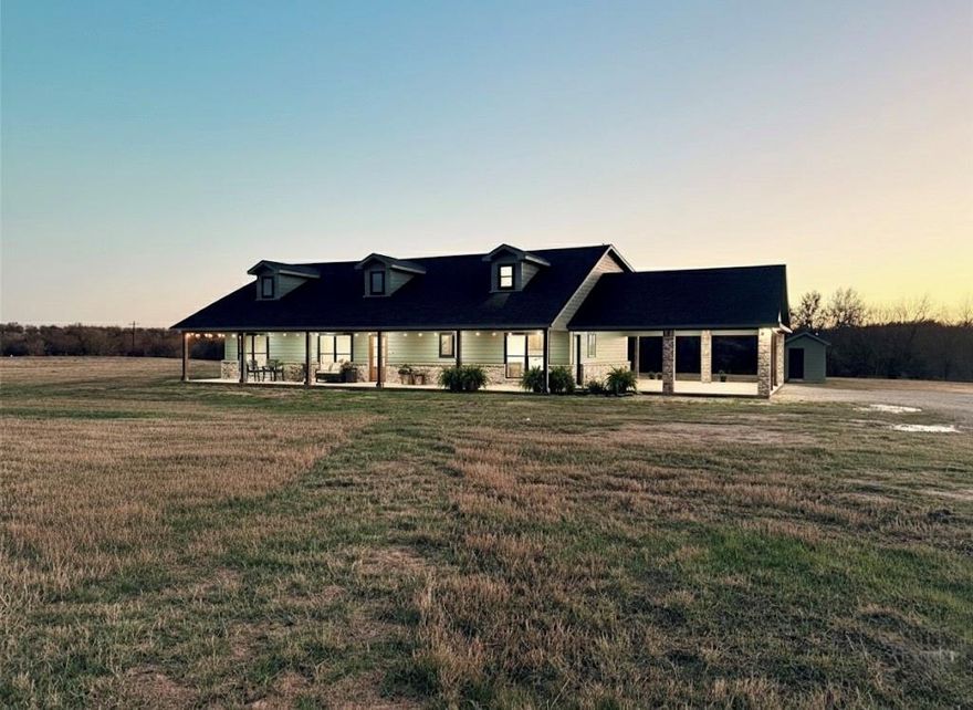 Tucked away in a peaceful and private setting, this thoughtfully designed home offers a rare blend of serenity and style. Surrounded by mature trees, rolling hills, a creek, and a pond just beyond the backyard, this property is currently the only home on the street, creating a true sense of quiet and seclusion. The calming sounds of nature welcome you the moment you arrive.
Inside, the home features four bedrooms, three bathrooms, and a spacious upstairs bonus room that offers endless flexibility as a game room, home office, or guest retreat. The living room is filled with natural light and showcases soaring ceilings, a striking wood beam, and double ceiling fans that add both comfort and character.
The kitchen is both beautiful and functional, highlighted by a farmhouse sink overlooking the wooded lot and creek, a built in drawer microwave, and stunning veined granite countertops. Rich, wood stained cabinetry flows throughout the home and is complemented by a mud bench in the laundry room and an abundance of natural light.
Step outside to the expansive wraparound porch with four ceiling fans, perfect for relaxing and enjoying the breeze on warm Texas summer days. The home also offers generous covered parking and is located within a thoughtfully planned neighborhood currently being developed with large tracts, some up to ten acres. This design ensures the area will never feel congested, allowing you to enjoy lasting privacy, open space, and the peaceful lifestyle this home was built to provide.