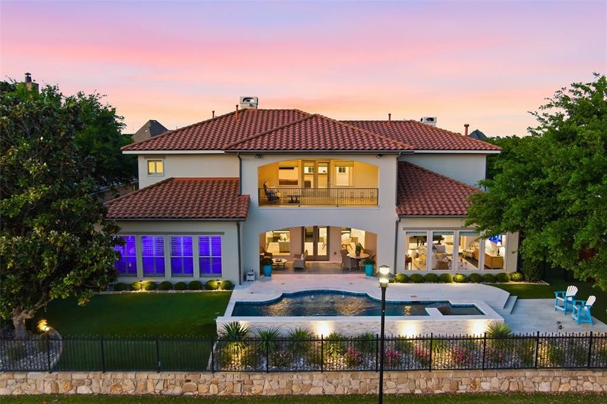 Discover the epitome of luxury in this rare 5-bedroom, 6-bathroom estate nestled in the exclusive gated community of The Lakes of Las Colinas. This stunning freshly renovated home backs directly onto picturesque Lake Carolyn, offering serene water views that define effortless elegance. Step through the enchanting courtyard and enter a private oasis designed for sophisticated living and effortless entertaining. Built with a custom floor plan and fully renovated, the residence showcases premium upgrades throughout. The heart of the home is the gourmet chef’s kitchen, featuring exquisite countertops, top-of-the-line Viking range, oversized fridge and freezer, convenient access to the butler’s pantry and an office that could be used as a 5th bedroom. Seamless flow connects the open-concept living, family, and dining areas, all framed by breathtaking lake views—ideal for hosting memorable gatherings or quiet evenings by the water. Retreat to the expansive primary suite, complete with its own stunning water views and a spa-inspired bathroom that invites pure relaxation. Upstairs continues to impress with two generous secondary bedrooms sharing a Jack-and-Jill bath, a dedicated media room perfect for movie nights, and a guest bedroom with its own private full bath. Recent changes include a substantial pool renovation with new equipment, new 3 stage HVAC units, standby generator, refreshed bathrooms, as well as numerous internal updates. This exceptional property blends timeless architecture, modern luxury, and resort-style living in one of Las Colinas’ most sought-after enclaves. Experience the ultimate waterfront lifestyle where every detail has been thoughtfully curated for comfort and distinction.