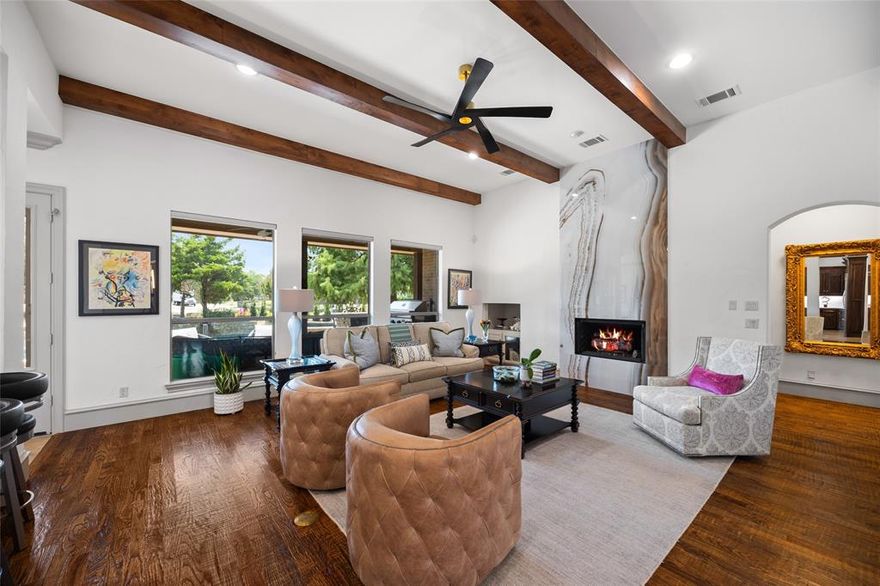 In the heart of Heath’s prestigious Wyndemere II, 401 Wyndemere Blvd offers the ultimate blend of luxury, privacy, and lifestyle—enhanced by over $200,000 in designer upgrades. Set on nearly an acre, this refined residence has been completely refreshed with updated paint, modern fixtures, LED lighting, new hardware, and custom touches throughout. The reimagined chef’s kitchen is a showpiece, featuring dual oversized islands, new quartz countertops & backsplash, induction cooktop, double ovens, new appliances, and a sleek butler’s pantry—perfect for both everyday living and grand entertaining.
The open-concept living room impresses with hand-scraped hardwoods, wood ceiling beams, and a striking floor-to-ceiling porcelain fireplace. Retreat to the spa-inspired primary suite, where an expanded glass shower, freestanding tub, lighted mirrors, quartz vanities, and curated finishes create a private sanctuary. Additional updates include remodeled secondary baths, new carpet, modernized stair balusters, and upgraded window treatments.
Step outside to your resort-style backyard—gunite pool & spa combo, outdoor kitchen, built-in BBQ, fire pit, and extensive landscaping with 30 mature trees for enhanced privacy. Zoned to acclaimed Rockwall ISD schools and minutes from Lake Ray Hubbard marinas, golf, and dining, this property offers the serenity of a retreat with quick access to Dallas business hubs.
More than a home, 401 Wyndemere Blvd is an elevated lifestyle—ready for its next discerning owner.