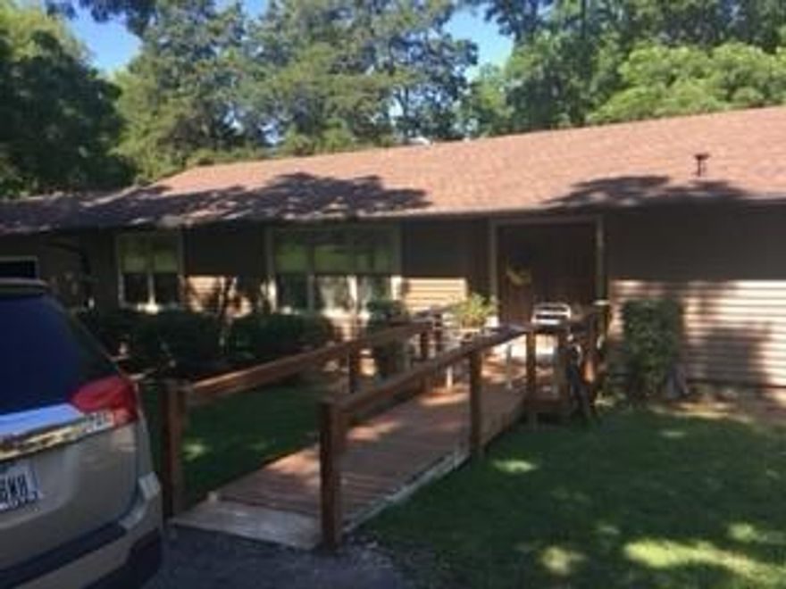 Lake living! 3Bdr home on 1.38 country acres just a block from the lake, walking distance to marina and ramp. Open floor plan with 2 large living area,  oversized rooms, kitchen features double over, island and breakfast nook. Bonus room is not fully complete but is private with it's own en suite (great mother in-law space). Huge mature trees (TONS of pecan trees), circle drive, workshop with electric, 2 car garage.  The roof and siding are fairly new (within 5 years) but the inside needs quite a bit of love.

Buyer to verify all information.