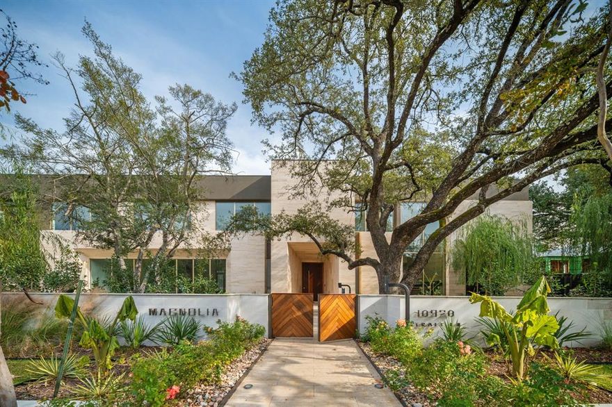 Set on legendary Strait Lane, 10920 is a modern estate that lives like a private resort—11,211 square feet on approximately .72 acres in prestigious Preston Hollow. Behind dual entry gates, clean lines and soaring ceilings create a striking first impression, while floor-to-ceiling custom windows draw in natural light and connect every space to the outdoors.

This home is defined by timeless materials and intentional design. Ojinaga limestone and Travertino Jalapa walls establish warmth and texture, complemented by white oak millwork that runs throughout—from custom cabinetry to beautifully finished closet interiors. The open chef’s kitchen is built for entertaining with premium appliances, generous workspace, and a dedicated wine room for effortless hosting. Visual Comfort lighting and statement chandeliers elevate the mood from day to night.

A downstairs primary retreat offers a spa-inspired bath with enclosed dual showers and an expansive custom closet with island. Multiple living spaces include formal dining, a sunlit living room with bar, private office with built-ins, media and game rooms, and a main-level guest or staff ensuite. Two utility rooms—one per floor—add everyday ease.

Step outside to a covered loggia, outdoor kitchen, pool, and firepit surrounded by mature trees, landscape lighting, and a private backyard sanctuary. A five-car garage and private balconies complete the experience—an exceptional opportunity on one of Dallas’ most recognized addresses.