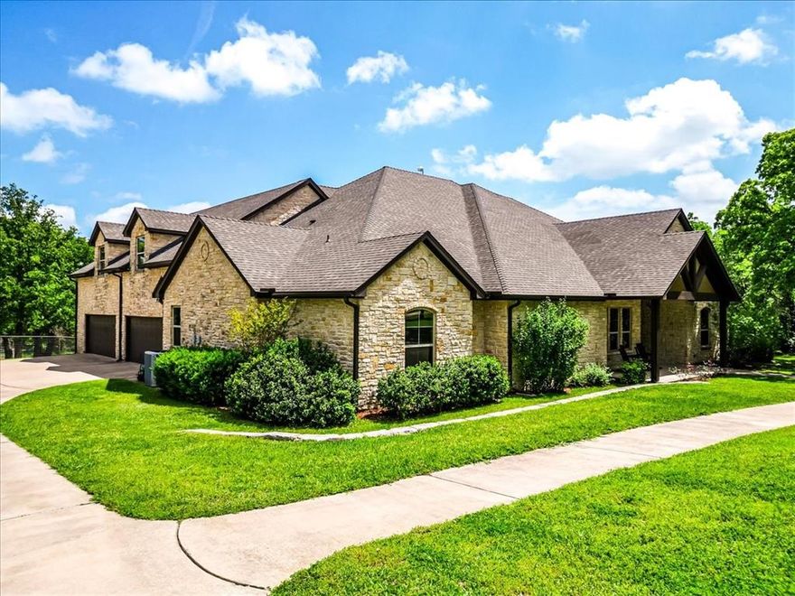 Set on 4.02 acres in Millsap ISD, this corner-lot property offers a functional layout, usable land, and a location that makes everyday living easy, with horses permitted. Conveniently located near Ric Williamson, you get quick access to Weatherford and I-20 while still enjoying a more private setting. The home offers approximately 5,668 square feet designed for both comfort and flexibility, featuring a vaulted living room with a floor-to-ceiling rock fireplace and expansive windows overlooking the back of the property. The kitchen is built for everyday living and entertaining with a large island, 48-inch range, walk-in pantry, and seamless flow into the breakfast area and formal dining. The primary suite is a true retreat, complete with its own fireplace, a spacious sitting area with three large windows, and a well-appointed bath with jetted tub, glass tile shower, and oversized closet with custom storage. Outdoor living is a standout feature, with an oversized covered back porch offering multiple seating and dining areas, an outdoor kitchen, and a private feel created by mature trees that provide natural screening while still allowing room for horses. The land is usable and functional, complemented by a 3-stall horse barn with tack room, feed room, and wash rack. Additional features include a dedicated office, secondary bedrooms with well-designed bath access, media room, game room, and an upstairs bedroom with private balcony, offering a strong combination of comfort, usability, and lifestyle in a growing area of Parker County.