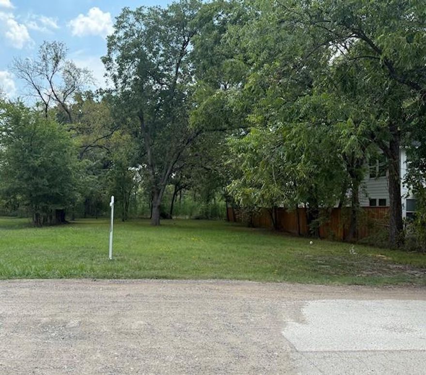 Beautiful trees on this 50x135 residential lot with newer homes being built in the area, this corner lot is ready for its home too! Lots of trees including large, mature pecan trees add privacy and beauty with welcoming shade for the yard. Active water meter used for watering grass and city sewer line on property. You'll find plenty of street parking for gathering friends or family while also being close to the downtown area and to Texas A&M-Commerce. The lot size fits those looking for lower yard maintenance. Could be a personal home or build to rent!