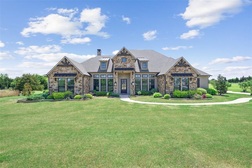 Beehives are located on the property and provide a tax exemption! Welcome to a slice of Hill Country heaven—where wide-open skies, rolling grassy acreage, and a private pond create the backdrop for this stunning 6-acre estate in the sought-after Hills of Lone Star subdivision for outdoor living and entertaining, the backyard is the heart of this property. Whether you're soaking in the hot tub, swimming in the sparkling pool, grilling in the outdoor kitchen, or gathering around the stone firepit, every detail is made for enjoying the beauty of the land. The covered patio offers ample space for relaxing or hosting, and the expansive lot gives you room to roam, garden, or simply take in the views under the shade of mature trees. Inside, this one-story home with an upstairs game room, built by Schramme Custom Homes, is just as impressive. Natural textures and timeless finishes bring the outdoors in—wood beams, a floor-to-ceiling stone fireplace, and a dramatic stone archway welcome you into the open-concept living space. The kitchen is a chef’s dream with a stone island, soapstone countertops, gas cooktop, and double ovens—all open to the living and dining areas, ideal for hosting and connection. Work from home in style in the private office with glass French doors and custom built-ins. The primary suite is a peaceful escape with trey ceilings, private access to the backyard, and a spa-style bath featuring a freestanding soaking tub, walk-in shower, and dual vanities. With four secondary bedrooms, a flexible sitting room, a game room with built-ins, sink and fridge, and a mudroom designed for daily ease, this home blends luxury with practicality. Throughout, you’ll find engineered wood floors, plantation shutters, and abundant storage. Tucked into the quiet countryside yet part of a welcoming community, this property offers the rare combination of space, style, and nature—a place to gather, unwind, and breathe easy. Come see what country living was meant to be.