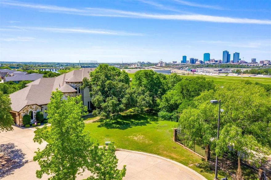 Vacant lot located in the gated community of Scenic Village with stunning views of the Downtown Fort Worth Skyline. The neighborhood is conveniently located off of Interstate 35 and minutes from Interstate 121 for a quick commute. The property is situated right off of the Trinity River, walking distance to the park and trails. Custom plans included with the lot. The perfect opportunity to build your new dream home!