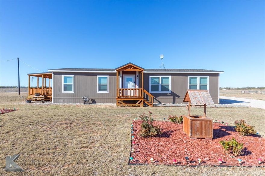 Discover this 2024 manufactured home situated on 1.9 acres just outside the city limits of Anson, Texas. This property offers a peaceful rural setting while still providing convenient access to surrounding communities, and is approximately 30 minutes from the new AI data center. The home features an open-concept layout with a well-designed flow between the living area, dining space, and kitchen. The kitchen includes a large island, an eat-in dining area, a pantry, and ample storage throughout. This three-bedroom, two-bath home offers a comfortable primary suite that includes a walk-in closet, double-sink vanities, a garden tub, and a walk-in tiled shower. A home ventilation system and a smart thermostat add to the property’s efficiency and comfort. The covered deck provides an outdoor space to enjoy the open views and West Texas sunsets. A shipping container located on the property will convey and can serve as additional storage or utility space. The land offers room for various uses, with space for parking, recreational equipment, small livestock (subject to county regulations and deed restrictions), gardening, or future improvements. Being outside the city limits allows for flexibility while still maintaining proximity to local amenities, schools, and major roadways. This property presents an opportunity for those seeking rural living, investment potential, or a full-time residence with acreage.