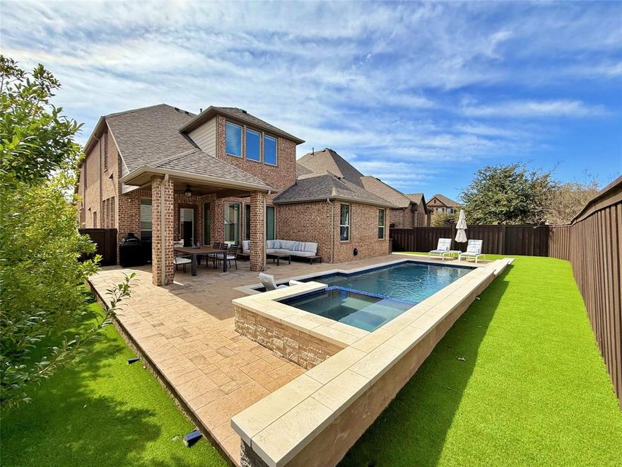 This absolute pristine Craig Ranch masterpiece in highly sought-after Southern Hills community blends luxury, and comfort within top-rated Frisco ISD. A beautifully tudor style home conveniently located right across from park delivering the ultimate backyard escape with everything needed for a perfect entertainment: an oversized backyard with extensive covered patio set up with a lounge & gourmet areas that open to a sparkling pool with spa surrounded by meticulously landscaped yard. Step into the home, and immediately feel the warmth and sophistication of the heigh ceilings, elegant dining room, an office, and wood floors throughout all social areas. The open floor plan seamlessly connects the kitchen, nook, and family room, creating an ideal space for both everyday living and entertaining. The kitchen is a chef’s dream at the heart of the home, equipped with top-of-the-line stainless steel appliances, luxurious Silestone countertops, a spacious center island, and custom cabinetry with hardware. The family room features custom shelving units, a contemporary stacked stone fireplace with gas logs adding to the cozy ambiance. There are 4 Bedrooms (master down), 3.5 bathrooms, a Gameroom, and a step down Media Room with 7.1 speakers! Enjoy a 3-car garage w hanging shelving for storage. This prime property boasts an excellent location near Highways 121 and 75, offering easy and convenient commuting. It is also close to top-rated schools, shopping centers, and a variety of dining options, making daily life effortless and enjoyable. You will be amazed!