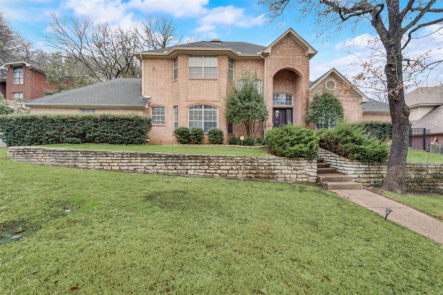 This gorgeous one-owner home in prestigious North Arlington has been beautifully cared for. It features an open floor plan with plenty of natural light. The elegant foyer makes a wonderful first impression with soaring ceilings and wood floors throughout the downstairs area. The dining room includes a wine cabinet and bar. Large living room with a cozy fireplace and built-in cabinets, overlooking green hill's view. The updated kitchen boasts stainless steel appliances, custom cabinets, and Quartz countertops. Relax in your master retreat, which includes a sitting area, dual closets, and a walk-in shower. Upstairs, you'll find three bedrooms and a cozy nook. The downstairs bedroom could serve as an office. The private backyard faces green hills and beautiful trees.