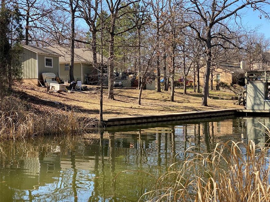 Looking for the perfect lot for a waterfront weekend retreat or full time tranquil living? Imagine driving off to summer camp, down a long paved country road and you turn into a modest neighborhood and find yourself surrounded by mature hardwoods. This hilly waterfront community has a very wooded and private feel. If you enjoy walking, jogging, biking or walking the dogs, the surroundings here truly beckon you to get outside and enjoy! This lot is located in one of the nicest communities on the lake which boasts amenities like boat launch, pool and tennis courts! Walking distance to neighborhood pool and tennis courts, easy for family and friends alike to share in the entertainment!This is a waterfront lot with excellent location protected from the open water wave action, very safe cove tucked away nicely for ease of navigation. You are allowed to have a private dock at your shoreline, permits issued by TRWD. Towering trees scattered all over this lot, making for a very woodsy and somewhat private feel to it's location. This lot has the adjoining lot also available, perfect opportunity to have the added elbow room, guest parking and seclusion of double lots.