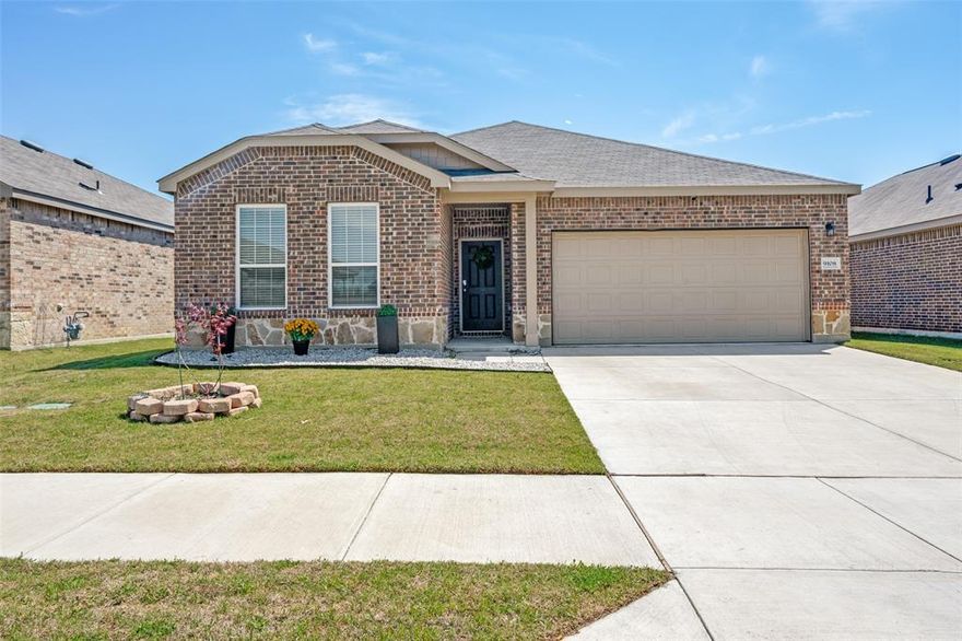 Better than new! Discover your dream home with this stunning two-year-old 3-bedroom, 2-bathroom home. Designed with energy efficiency in mind. Step inside this open concept kitchen and living area, perfect for entertaining. The space is bathed in natural light from numerous windows, and a gorgeous fireplace with remote control adds to the ambiance. The kitchen is a chef's delight, equipped with stainless steel appliances, island, microwave, gas cooktop, quartz countertops, a spacious island, and a large pantry. Relax in the luxurious master suite, which offers an ensuite with a garden tub, separate shower, double sinks, and a spacious walk-in closet. Additional features include a covered patio and sprinkler system. Refrigerator in the kitchen & washer & dryer are included. Enjoy the Community Swimming pool.. Located Less than 15 minutes from downtown Ft Worth. Close to shopping & restaurants