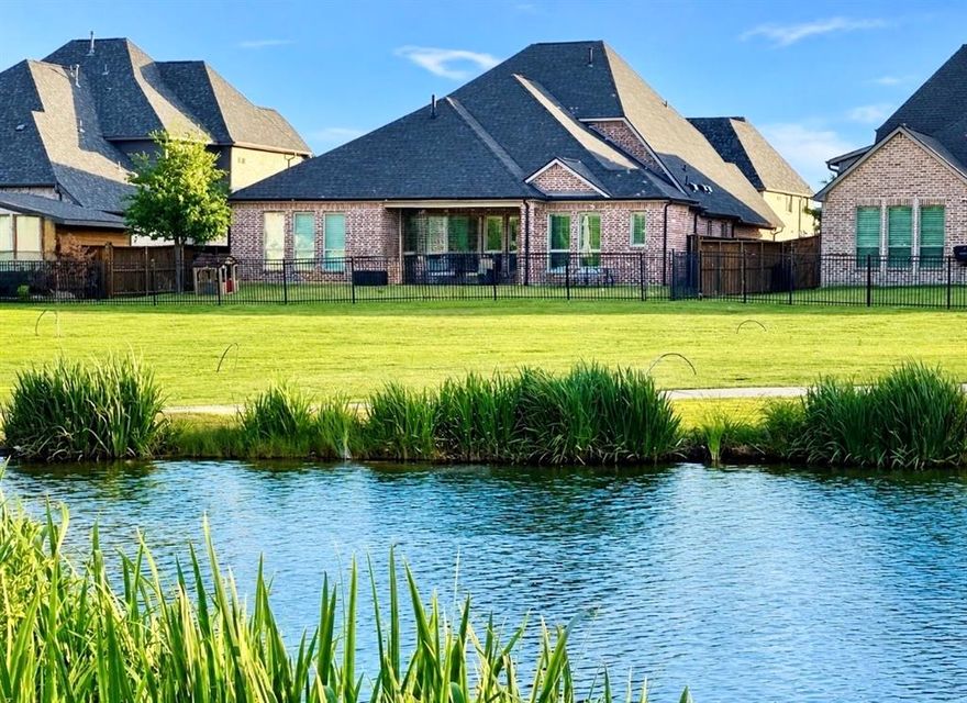 Waterfront Living in Light Farms! Rare opportunity to own a premium lakefront lot with no backyard neighbors in one of Celina’s most sought-after communities for UNDER $900,000! This upgraded 2-story home offers 4 bedrooms (including added bedroom), 3.5 baths, and a 3-car garage with spacious, flexible living areas designed for modern life. Serene, unobstructed water views, spectacular sunsets, luxury Shaddock craftsmanship and resort-style living in the coveted Light Farm community — this home is truly unique. The light-filled open floorplan features hand-scraped hardwood floors, soaring ceilings, and inviting living spaces designed for both everyday living and entertaining. The chef’s kitchen includes granite countertops, ss appliances, custom cabinetry, an oversized wood vent hood, and a built-in wine fridge with bar area. The private primary suite overlooks the water and features a spa-like bath with a soaking tub, separate oversized shower, and walk-in closet. The flexible layout also includes a guest suite, private office, game room & media room, and additional bedrooms and baths. Enjoy outdoor living on the covered porch with easy access from the backyard gate to walking trails and the best stocked fishing pond in Light Farms, right behind the home. Additional highlights include a 3-car garage, storm shelter, and recently replaced roof. Residents of Light Farms enjoy exceptional amenities, including onsite schools in Prosper Independent School District, lakes, playgrounds, a dog park and over 13 miles of trails. This is one of the closest water-front homes in Light Farms to Homestead Court! Easy walk to Nook restaurant & bar with poolside service, the gym, pickleball courts, basketball courts, Light Farms Elementary and regular community events.