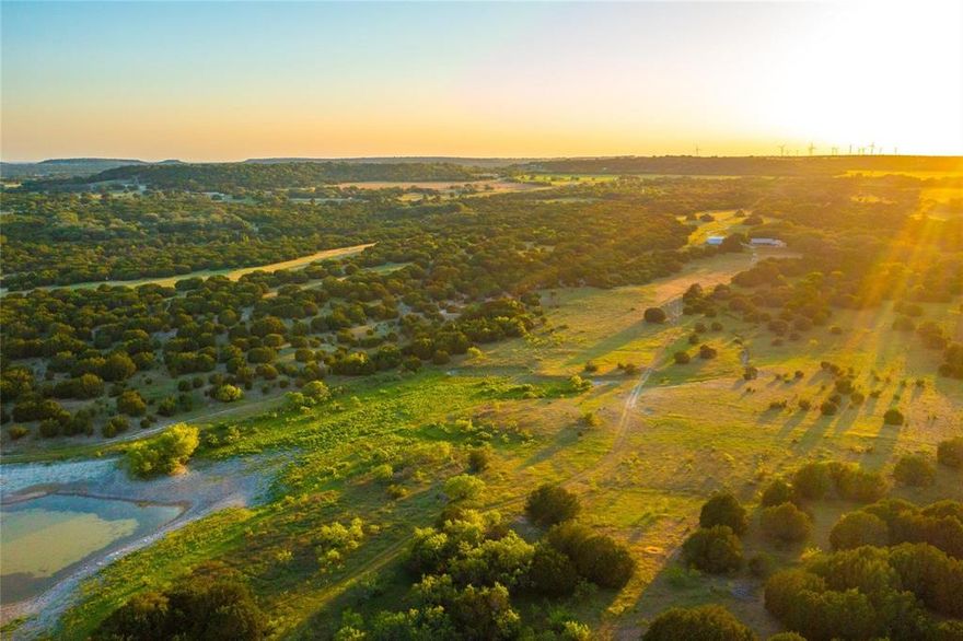 Located in the heart of Lampasas County, just 8.5 miles northwest of Lometa, this 665-acre ranch offers a rare mix of natural beauty, privacy, and well-planned improvements. With over 3,550 feet of county road frontage off CR 2699, the property is easily accessible yet feels worlds away. The land showcases rolling Hill Country terrain, mature oak groves, open pastures, and two stocked lakes, plus a natural spring that flows year-round. Historic features like original wagon tracks and a century-old homestead site add authentic Texas character. A custom 2,038 sq. ft. residence with 5 bedrooms and 3 baths anchors the property. Designed for both comfort and entertaining, the home includes spacious living areas and outdoor access. Additional improvements include a large workshop and a separate storage building—ideal for tools, ranch equipment, and operational use. A private well serves the home and improvements. Recreational appeal is strong, with whitetail deer, turkey, and other native game supported by ideal habitat. Multiple blinds, feeders, and water sources are already in place, making this a turnkey setup for hunting and outdoor enjoyment. The property is well-suited for cattle, wildlife management, or a private family compound. Less than 30 minutes to Lampasas and under 2 hours from Austin, Waco, and San Antonio, Wagon Trail Ranch offers a rare combination of seclusion and convenience in one of Central Texas’ most desirable regions.