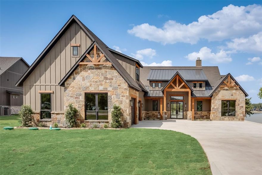 This newly built home in the desirable Shores subdivision is a show stopper! Prepare to be taken aback as you enter through the stunning, iron double doors and greeted with a vast open concept layout. Elegantly designed, you will find an impressive mix of industrial finishes and natural wood accents throughout the home. The main living space is bathed in natural light from oversized windows giving you unobstructed views of Richland Chambers Lake. The kitchen is adorned with leathered granite countertops, stained soft close cabinets, and Frigidaire gallery appliances. Out back, the covered patio exceeds all your entertaining needs from the huge sliding doors, fireplace and the luscious green space. Take the stone steps to your maintenance free, private boat dock. You also have two boats slips with a lift in place! Enjoy peaceful evenings with approx. 140 ft of lake frontage in a protected deep cove of Richland Chambers Lake. This home goes above and beyond, come see it today!