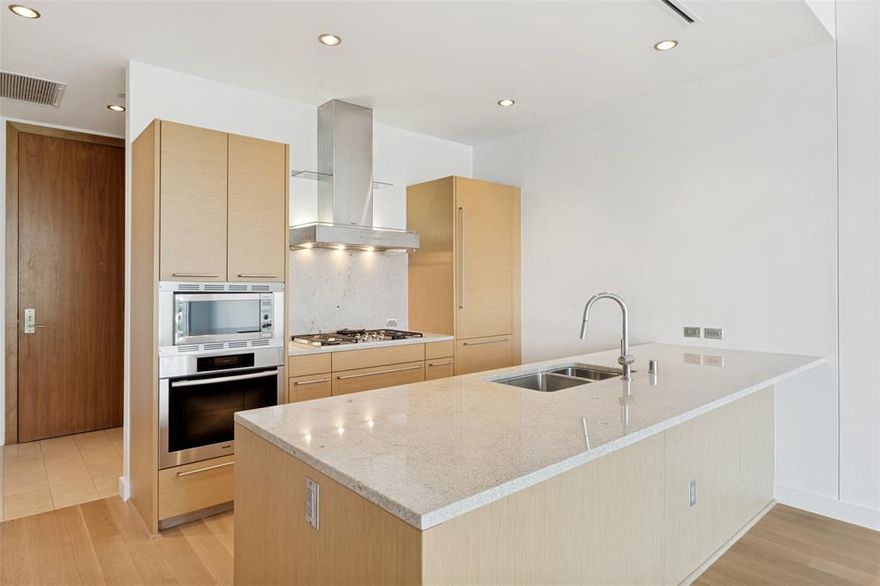Welcome to this beautifully renovated one-bedroom residence on the 4th floor, perfectly positioned on a quiet, serene side of the building. Unit 406 has just recently been thoughtfully renovated, offering a move-in-ready experience with every detail carefully considered. When you walk in, it smells of brand-new interiors including fresh paint and Harwood oak floors throughout.

The white oak hardwood floors bring warmth and sophistication to the space. The kitchen is equipped with premium Miele and Sub-Zero appliances, blending luxury with top-tier performance.

The spacious primary suite offers a spa-like bathroom complete with dual sinks, a soaking tub, a separate full shower, and a generous walk-in closet. Step outside to your private patio and unwind by the cozy fireplace, conveniently operated by remote—perfect for relaxing evenings.

This exceptional residence also includes a private one-car garage, adding both convenience and security—an uncommon and highly desirable feature.

With all systems serviced and in excellent working condition, this home offers both comfort and peace of mind in a tranquil setting. The building is conveniently located just off the tollway with over 100 restaurants within walking distance from your home.