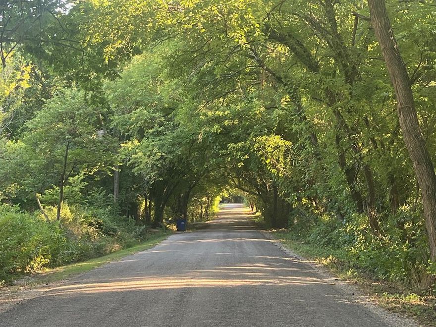 Motivated Seller!  Drive under a leafy canopy along Smith Oak Road—accessible from either the north or south side—and arrive at this enchanting unrestricted 1+ acre lot. Towering, mature trees offer both shade and natural appeal, setting the stage for your future home. The property is already primed for a build, with an aerobic septic system, water service, a temporary power pole, and a storage building in place.

An RV currently resides on site, but a cleared and leveled pad awaits your vision. Fenced on three sides, the lot features a graceful curved drive giving you a pleasing approach to the homesite. Enjoy cool morning shade and dramatic sunsets across open skies.

Located just outside Sherman’s city limits, you get the best of country peace and future growth. Sherman is booming—major infrastructure projects are underway, and the city has landed massive semiconductor manufacturing facilities (including a Texas Instruments campus and a GlobalWafers project) that promise thousands of jobs and transformative development.   The city also approved a 200-acre mixed residential-retail development to absorb rising demand. With such momentum, now is the moment to stake your claim on land that offers both tranquility today and growth tomorrow.

Isn’t it time to Come Home Where You Belong?