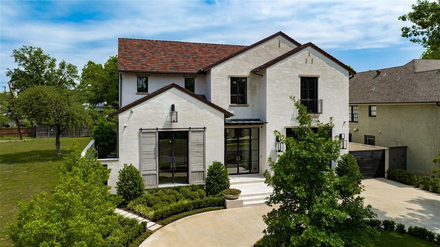 Located steps from Highland Park Village, this transitional Mediterranean home boasts Ludowici clay roof tiles, slurried brick, & floor-to-ceiling Kolbe windows & exterior doors. The entry is flanked by formals, & leads to the study. The kitchen opens to a large breakfast space & family room, featuring 60” Wolf Gas Range, Wolf electric oven & microwave, Subzero refrigerator, freezer, & wine storage. The family room is centered around the fireplace & flanked by floor-to-ceiling windows that overlook outdoor spaces with direct access to the bar. Upstairs, you'll find 5 bedroom suites, a 2nd living area & a laundry room. The primary retreat includes a coffee bar outside the door, large vaulted ceilings, a sitting area, dual separate bathrooms & separate closets. Additional features include an elevator, Generac Generator, walnut floors, designer lighting, Kallista & Waterworks plumbing fixtures, 3-car garage, and electric shades throughout.