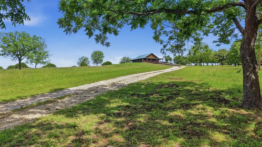Charming hilltop, ranch style log cabin with full, covered wraparound porch on 7.39 scenic acres in Montague County, with beautiful views of the surrounding countryside, located in Saint Jo ISD. This Ranch Style Cabin features a full wraparound covered porch, 2 bedrooms & 2 full bathrooms on 1st floor with a half bath & 2 flex rooms in the basement that can be used as additional bedrooms, an office, sewing room or game room-man cave. HUGE garage with room for storage & work area. Large kitchen with island that open to the dining and living areas. Property also offers covered parking, septic system, propane and private well. Ideal for those seeking acreage with privacy while still enjoying modern conveniences. Plenty of room for animals, gardening, or future expansion. If you like peace & quiet with gorgeous country views then hurry out here!