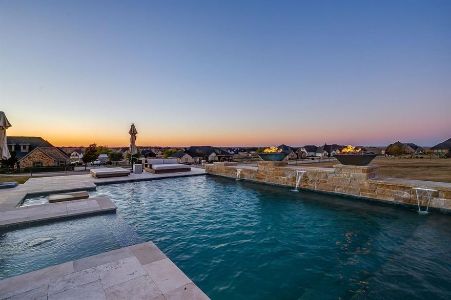 Set on a desirable corner lot just 20 minutes from Downtown Fort Worth with convenient access to the Chisholm Parkway Toll, this custom home by Open Prairie Custom Homes offers refined design, quality craftsmanship, and exceptional indoor-outdoor living in a growing community. The well-planned layout features 4 bedrooms, 3 bathrooms, and a 3-car garage, with a thoughtful mix of wood flooring and travertine that adds warmth and timeless appeal. Recent updates include brand new appliances, including dishwasher, range, and microwave, and new exterior light fixtures. A home water filtration system and softener enhances everyday comfort, and the landscaped setting adds curb appeal and privacy.

The backyard is designed for year-round enjoyment with a heated and chilled pool and an outdoor living experience inspired by Texas Hill Country resorts. The covered patio is enhanced with automated shades that partially enclose the space, infrared heaters, speaker lights with Alexa integration, and a Big Ass Fans ceiling fan, creating a comfortable backdrop for entertaining or quiet evenings at home. Enjoy beautiful Texas sunsets from your own private retreat.

Located within a short drive to The Shops at Clearfork, Texas Christian University, Downtown Fort Worth, and more, this home combines custom luxury with an accessible location and resort-style amenities. A rare opportunity to secure a move-in ready, thoughtfully upgraded property with standout outdoor features near Fort Worth.