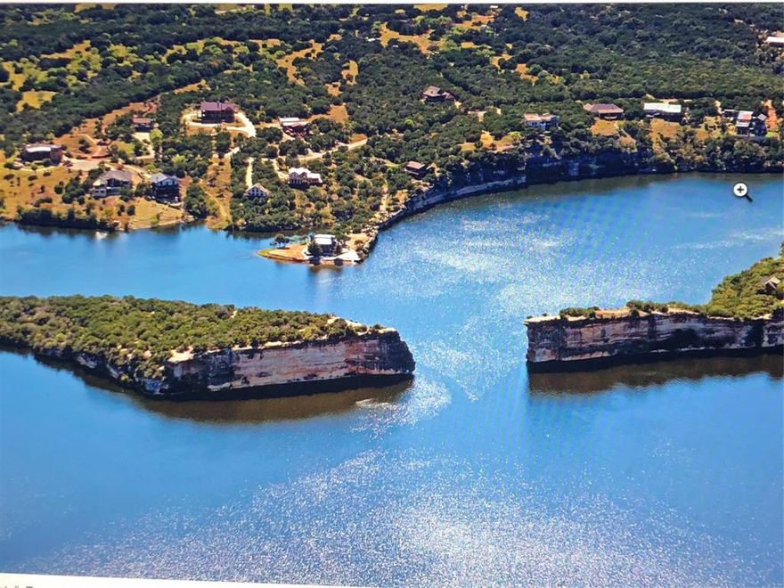 Interior lot with a fantastic view of Hell's Gate. Lot previously had a house on it. House Pad in place. Water & Sewer taps already done. Large 1.2 acre lot. Opportunity to build your dream lake house with a tremendous view of Hell's Gate, the icon of Possum Kingdom Lake.  Very few lots have this view. Take this opportunity to jump on this and begin creating your own families memories. Get your own custom home builder to create life long memories. AND remember, Lake kids are the best kids. Spoil your family. The Lake life awaits you. Keep your boat over at Bluff Creek Marina for easy access to the lake.