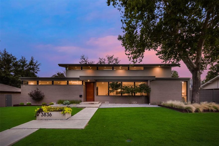 Discover modern luxury at 3836 Pallos Verdas Dr, nestled in Dallas' coveted private school corridor, zoned to Withers Elementary. This 2019 masterpiece, constructed by a builder as his personal home, spans 4877 SF on a .4-acre lot. Featuring striking walls of glass and warm wood details, the home boasts a magnificent floating staircase in the entry which opens to an expansive and welcoming dining room. 
A minimalist kitchen design opens to a generously sized living room and separate eat-in kitchen. A wall of sleek cabinetry conceals an enormous walk-in pantry and prep space.
The downstairs primary suite offers views of the backyard oasis, a private exercise room, and a custom closet with a storage island and vanity area.
The yard is an entertainers dream with expansive covered living space, swimming pool, and cabana bath on a fully turfed yard. 
Upstairs is a game room plus three bedrooms, all of which have custom electric blackout shades and access to an expansive terrace.