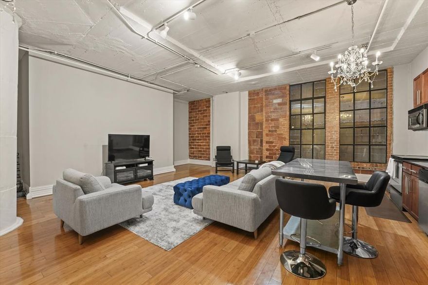 Welcome to this sophisticated 1-bedroom, 1-bathroom condo at The SoCo Urban Lofts, a highly sought-after Downtown Dallas address. This spacious residence features an open-concept layout with hardwood floors and elegant chandelier lighting. The kitchen boasts stainless steel appliances, granite countertops, and a central island. The spa-inspired bathroom offers an oversized tub-shower combo and sleek dark tile. Enjoy elite amenities including a rooftop pool with grilling area, media room, state-of-the-art fitness center, personal storage, in-building laundry, and 24-7 security with concierge. One of Downtown's most competitive HOA fees covers water, trash, sewer, insurance, parking, and internet. Perfectly located, this condo is within walking distance of the AT&T Discovery District, biking-walking trails, the Farmers Market, Neiman Marcus, and diverse dining and entertainment. Experience a rare urban sanctuary blending low-maintenance luxury with exciting city living. Schedule your visit today!