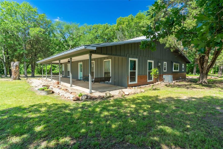 Welcome to the country! This AMAZING property is located in highly sought after Lone Oak ISD featuring a 3 bed 2 bath rustic country home on almost 10 acres! Experience your own private cabin tucked in the woods surrounded by trees and relax on your full length front and back porch. This energy efficient beauty features a metal roof, wood-burning fireplace, stained concrete floors, a vaulted ceiling, cedar board and batten siding, whole house attic fan, tankless water heater and low-E window updates. Kitchen features updated granite countertops, stainless appliances with farmhouse sink overlooking a meadow and garden. Gather eggs from the large chicken coop a few steps off your porch or take a hike on the acres of trails in the dense woods. Also featuring a 1500 sqft agriculture barn with 60 amp electrical service and detached carport! 20 minutes away from Greenville, Sulphur Springs, Emory, Lake Tawakoni and Lake Fork, and only 30 minutes from Canton! Don’t miss this country beauty!