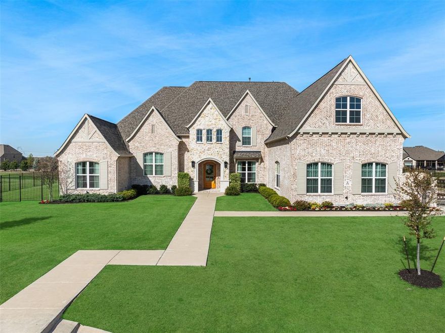 Experience the pinnacle of luxury in this one-of-a-kind masterpiece built by Shaddock Homes.  Situated on a serene 1-acre lot this estate boasts luxurious features throughout. With $550k+ in builder upgrades and aftermarket enhancements, this must-see home has it all.  Every detail exudes timeless elegance and curb appeal.  Step inside to discover 6,545 square feet of thoughtfully designed living space, featuring 5 bedrooms and 5 full and 3 half baths and gorgeous white oak flooring. A stunning vaulted beam ceiling crowns the great room anchored by a sleek white stone fireplace, while oversized panoramic windows frame serene views and bathe the space in natural light. The heart of the home is not one but TWO kitchens.  The chef’s kitchen features a waterfall island, striking two-tone cabinetry, quartz slab backsplash and designer pendant lighting. The fully equipped catering kitchen is perfect for seamless hosting for any occasion.  The open design is highlighted by a 16 ft sliding door that provides access to the covered patio, creating an indoor-outdoor living experience. The primary suite is a true retreat, offering a spa-inspired bath with dual vanities, a glass-enclosed rainfall shower, soaking tub, and two walk-in closets. Entertainment is refined in the media room, equipped with an Epson 4k projector, Denon receiver and 7-speaker surround sound. Two built-in bars offer a sophisticated touch for hosting friends and family. A secluded Jr. guest suite with ensuite is ideal for in-laws or visiting guests. The home offers two separate office spaces, providing a quiet retreat for productivity.  Upstairs, the home continues to impress with a large game room, 3 additional bedrooms with ensuites.  This home is loaded with high-end tech and comforts, including an Ecowater system, Jellyfish outdoor lighting, remote controlled shades, custom drapes and 4-car garage.  This exceptional property combines luxury, and a curated lifestyle - ready for the most discerning buyer.