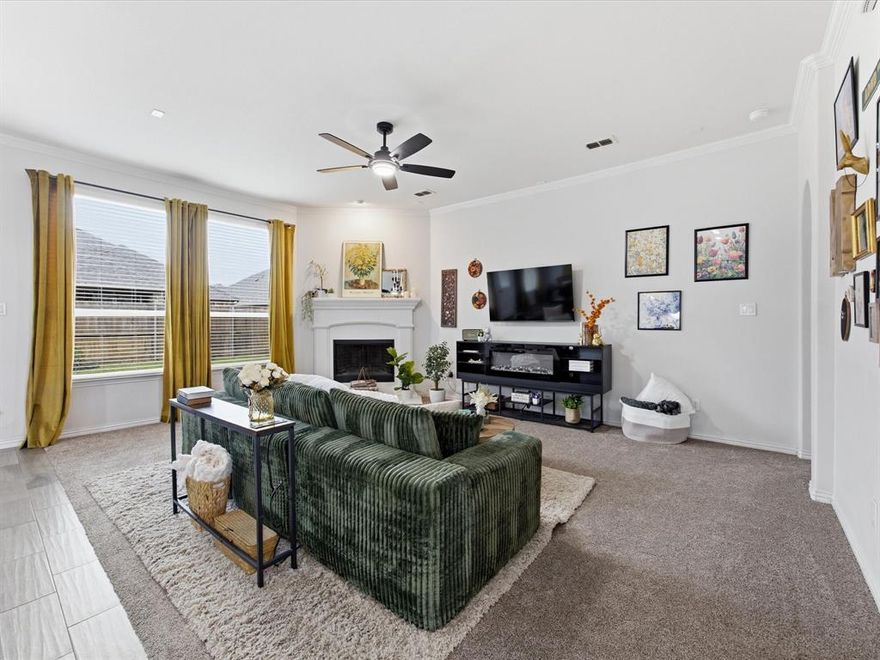 Welcome to a spacious and thoughtfully designed two-story home located in the desirable north Fort Worth Alliance corridor. This home offers a functional layout with multiple living spaces, modern conveniences, & easy access to shopping, dining, & major highways, making everyday living both comfortable & convenient. Inside, the home features a bright, open layout with two living areas—one on each level—offering flexibility for everyday living & entertaining. The main living room flows seamlessly into the kitchen & dining area, creating a comfortable space for gatherings.

The kitchen is designed for both style & functionality, featuring ample cabinetry, generous counter space, & abundant storage. A frosted glass door  pantry with a provides additional organization while maintaining a clean, modern aesthetic. Stainless steel appliances, gas stove, pendant lighting, & a spacious layout.

The primary suite offers a relaxing retreat, highlighted by an electric fireplace & built-in shelving, creating a cozy & inviting atmosphere. The ensuie bathroom & walk-in closet put the icing on the cake. All secondary bedrooms are located upstairs along with a sized full bathroom.

Upstairs, a second living area serves as a game room or bonus room, while the dedicated media room with French doors creates a true theater-style experience for movies, sports, or gaming nights. 

Fresh paint & new carpet!! The home also features practical touches throughout, including additional storage beneath the staircase & EV charger outlet in the garage. A beautiful backyard with a covered patio, you can enjoy year round & low-maintenance landscaping. The home offers quick access to Highway 170, Highway 114, & I-35W, making commuting throughout the DFW Metroplex convenient. Shopping, dining, and entertainment are just minutes away at Alliance Town Center, with major retailers, restaurants, entertainment venues, & everyday services. H-E-B is less than 10 minutes away!