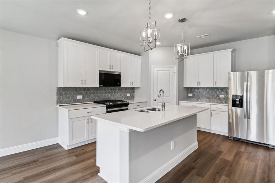 BRAND NEW energy - efficient home Dec 2025! The spacious living area flows seamlessly outdoors to the covered back patio. White cabinets with veined white quartz countertops, beige tone EVP flooring with beige tweed carpet.