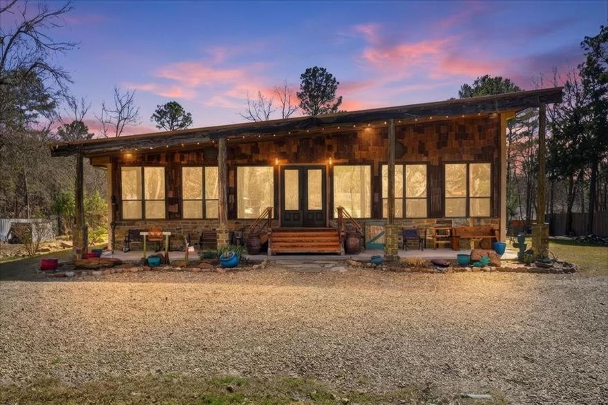 Discover one of the most distinctive homes in Hawkins — just a short walk from the lake — where craftsmanship, durability, and character meet comfort at every turn. Custom built from the inside out, this property showcases remarkable attention to detail you simply won’t find in a typical home. Constructed with a steel frame build engineered to withstand up to an F4 tornado, this home offers exceptional structural integrity and peace of mind. Paired with R-30 insulation throughout, you’ll enjoy impressive energy efficiency and significant savings on electricity year-round — a rare combination of strength and smart design. Step inside to rich custom hardwood flooring throughout, highlighted by a stunning inlaid walnut floor in the primary suite — a true statement of artistry. The kitchen features beautifully crafted, custom-cut rustic hickory cabinetry, upgraded appliances, and thoughtful design that blends warmth with functionality. Handcrafted front and back doors add to the home’s unique charm and welcoming presence. The spacious primary bathroom offers a spa-like retreat with a luxurious walk-in shower and elevated finishes designed for relaxation. The open floor plan flows effortlessly into the oversized living area, where a wood-burning stove creates a cozy focal point — perfect for gathering on cool East Texas evenings. Outside, the nearly one-acre property is meticulously maintained and fully equipped for both relaxation and productivity. Front and back sprinkler systems keep the grounds lush year-round, while a 20x30 shop with 10-foot overhangs on both sides provides ample space for projects, storage, a workshop, or the ultimate hobby retreat. The property is fully fenced and gated, offering privacy and security for pets and outdoor living. From the handcrafted finishes to the storm-ready steel construction and energy-efficient design, every inch of this home reflects intentional planning and pride of ownership — a truly rare and resilient find in Hawkins.