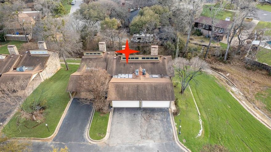 Ideally located just 10 minutes from Downtown Fort Worth on the east side, this beautifully updated townhome backs to the community’s tree-lined greenbelt with a seasonal creek, offering peaceful views and a tranquil setting - perfectly positioned between Fort Worth and Arlington. This compact in size, yet large in functionality and charm, townhome boasts an open-concept layout that seamlessly connects the living, kitchen, and dining areas. As you step inside, you’re greeted by an inviting living room with vaulted ceilings and a cozy fireplace, perfect for both family relaxation and entertaining guests. Prepare meals in the stylish and functional kitchen, featuring crisp white cabinetry that contrasts beautifully with the black fixtures and appliances. Just off the dining area, an upper balcony provides the perfect spot to savor your morning coffee while enjoying the serene views. A versatile space near the entry can easily function as a second dining area or home office. Privacy is not a concern, as both bedrooms are located on the lower level. The primary suite features a dedicated bath with separate vanities and direct access to a secluded patio. Comfortably sized, the secondary bedroom is near a full bath with a rustic-chic vanity and vessel sink. Community amenities include a clubhouse, sparkling pool, tennis courts, and scenic walking trails. Enjoy easy maintenance living as the HOA maintains the grounds. Prime location with easy access to Interstate 30, Highway 820, and a variety of shops, restaurants, recreation, and local attractions, including AT&T Stadium, Globe Life Field, and the Fort Worth Stockyards.