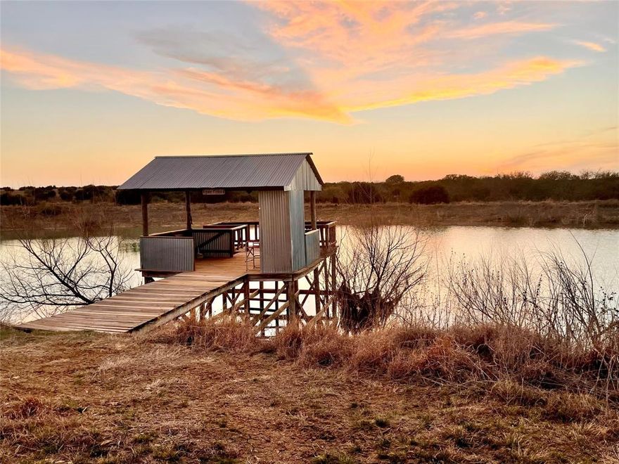 Looking for a place where life slows down, and the country welcomes you home? This beautiful 93-acre ranch offers the perfect blend of peaceful country living and convenient access to town, located just 8 miles from historic downtown Hico, Texas. Set atop a scenic hill with views of the surrounding countryside, the 2,640 sq. ft. modern farmhouse captures the true spirit of ranch living while offering comfort and a relaxing design throughout the home and property.

This ranch is a wildlife enthusiast's dream. The seller has carefully maintained a wildlife exemption on the property, encouraging native habitat and preserving natural brush areas that attract a wide variety of animals. Wildlife is abundant with sightings of quail, deer, turkey, dove, fox, and many other species throughout the ranch, creating a peaceful setting where nature thrives.

The thoughtfully designed main home features two bedrooms, two baths, a formal dining room, two wood-burning fireplaces, and a spacious family room perfect for gathering with friends and family. The sunroom adds extra versatility with a custom swing bed for guests, a third dining area, and an open layout ideal for entertaining. A generous 12 x 40 covered front porch provides the perfect place to relax in the evenings while enjoying wildlife sightings and breathtaking sunrises. 

Additional improvements include an oversized two-car carport, a 2,000 sq. ft. barn with water and separate electric service, and a 1,200 sq. ft. workshop featuring air, heat, water, sewer, and a covered patio.

The crown jewel of the ranch is the beautiful 1.5-acre stocked lake (Bass, Crappie & Bluegill) with a dock, perfect for fishing. Bailey Branch Creek winds through the property, drawing wildlife and adding to the ranch’s natural beauty. The land is fenced and cross-fenced for cattle or horses with mature trees and native grasses. This is an opportunity to enjoy ranch living just minutes from the charm of Hico.