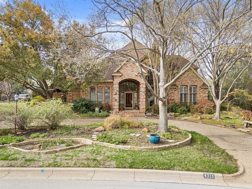Discover this charming home in the much-desired Woodland Hills neighborhood in Colleyville. You'll find outstanding features and easy living in this 4 BR, 3.5 BA home on .66 acres! Flower gardens, perennial blooms, beautiful trees and foliage are immediately on display in the landscape. Formal dining and living greet you as you enter and immediately you're drawn to the floor-to-ceiling windows providing abundant natural light with views to the pool and outdoors. Discover the updated chef's kitchen with granite countertops, island, Thermador induction cooktop, Jenn Air double ovens, Subzero refrigerator, microwave, trash compactor, and warming drawer. From the Kitchen, enjoy sightlines into the breakfast area and casual living room with brick fireplace and wet bar area with dual wine fridges. Select and pour from your cedar-lined wine closet with 400 bottle capacity! Beautifully tucked off the living area is an office with built in bookcases and cabinets. The owner's primary suite includes a cozy sitting area and is located downstairs, along with a private guest bedroom with vaulted, beam ceilings. The primary bath has built-ins, separate shower, separate vanities and courtyard garden views! Journey upstairs to 2 BRs with jack and jill bath and a flex space that can be used for an exercise room, second office, or reading room. Step outside to covered porches, outdoor grilling, and salt water pool with spa. Outside you'll find courtyards, vegetable and herb garden spaces, a private lot backing to green space, access from your yard to the neighborhood walking path, and wonderful Melrose Park is an easy stroll away. Note other details like beamed and coffered ceilings, shutters, courtyard views, 3 car garage with work space, sprinkler system, custom built-ins, and lots of storage. Quick access to DFW airport, restaurants, retail and zoned to acclaimed GCISD Heritage schools. View this lovely home and make it yours!
